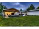 A backyard featuring an outdoor living area with comfortable seating, a grill, and a well-manicured lawn at 1100 E Harvey St, Castle Rock, CO 80108