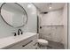 Modern bathroom features a white vanity, black fixtures, and a sleek glass shower at 1100 E Harvey St, Castle Rock, CO 80108