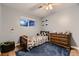 Cozy bedroom featuring a race car themed bed set and natural wood dresser at 1100 E Harvey St, Castle Rock, CO 80108