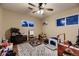Bright bedroom features a ceiling fan, area rug, and play and learning area at 1100 E Harvey St, Castle Rock, CO 80108