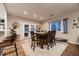 Bright dining room with french doors, wood table set, and view into the backyard at 1100 E Harvey St, Castle Rock, CO 80108