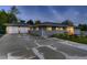 Charming home with a two-car garage and spacious cracked driveway at dusk at 1100 E Harvey St, Castle Rock, CO 80108