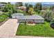 Charming single-Gathering home with a well-maintained lawn, mature trees, and a detached two-car garage at 1100 E Harvey St, Castle Rock, CO 80108