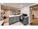 This open kitchen features gray cabinetry, modern appliances, and leads into the living room at 1100 E Harvey St, Castle Rock, CO 80108