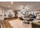 Spacious living room with a large sectional, opening to the dining area and a glimpse of the kitchen at 1100 E Harvey St, Castle Rock, CO 80108