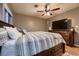 Spacious main bedroom featuring hardwood floors, a ceiling fan, and natural lighting at 1100 E Harvey St, Castle Rock, CO 80108