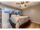 Cozy main bedroom with hardwood floors, ceiling fan, and plenty of natural light at 1100 E Harvey St, Castle Rock, CO 80108