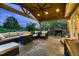 Covered patio features a built in fire pit and an outdoor dining area at 1100 E Harvey St, Castle Rock, CO 80108