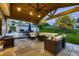 Covered patio featuring a built in fire pit and an outdoor dining area at 1100 E Harvey St, Castle Rock, CO 80108
