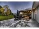 Backyard features an outdoor dining area and a covered lounge area at 1100 E Harvey St, Castle Rock, CO 80108