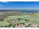 An aerial view of a neighborhood with scenic views of a lake, mountains, and city skyline at 13806 E Chenango Dr, Aurora, CO 80015