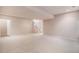 Unfurnished basement area with neutral carpeting and staircase to upper level at 13806 E Chenango Dr, Aurora, CO 80015