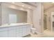 Bathroom featuring double vanity, shower and separate toilet area at 13806 E Chenango Dr, Aurora, CO 80015