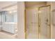 Updated bathroom featuring tiled shower with glass door and double vanity at 13806 E Chenango Dr, Aurora, CO 80015
