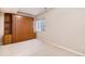 Bedroom featuring a built-in Murphy bed and a window allowing natural light at 13806 E Chenango Dr, Aurora, CO 80015