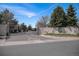 Well-maintained gated community entrance with stone accents and mature landscaping at 13806 E Chenango Dr, Aurora, CO 80015