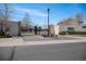 Elegant gated community entrance featuring stone accents and beautifully landscaped grounds at 13806 E Chenango Dr, Aurora, CO 80015