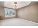 Elegant dining room with a chandelier and large windows, perfect for Gathering gatherings at 13806 E Chenango Dr, Aurora, CO 80015