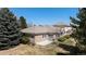 Stunning home featuring stone accents, a tile roof, and a private patio area at 13806 E Chenango Dr, Aurora, CO 80015