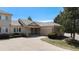 Charming home featuring stone accents, a tile roof, manicured landscaping, and a two-car garage at 13806 E Chenango Dr, Aurora, CO 80015