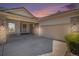Charming home featuring stone accents, a tile roof, manicured landscaping, and a two-car garage at 13806 E Chenango Dr, Aurora, CO 80015