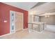 Inviting foyer with tile flooring, a red accent wall, a wooden front door, and staircase access at 13806 E Chenango Dr, Aurora, CO 80015