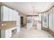 Bright kitchen with an island, desk area and white cabinetry for ample storage space at 13806 E Chenango Dr, Aurora, CO 80015