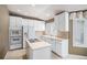 Well-equipped kitchen featuring modern appliances, ample cabinet space, and neutral countertops at 13806 E Chenango Dr, Aurora, CO 80015