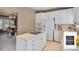 Well-lit kitchen with white cabinets, center island cooktop, and stainless-steel appliances at 13806 E Chenango Dr, Aurora, CO 80015