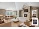 Spacious living room features a cozy fireplace, large windows, and elegant neutral furnishings at 13806 E Chenango Dr, Aurora, CO 80015