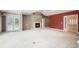 Bright living room featuring a fireplace, plush carpeting, neutral tones, and access to outdoor space at 13806 E Chenango Dr, Aurora, CO 80015
