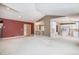 Bright, open-concept living space with red accent wall and adjoining kitchen at 13806 E Chenango Dr, Aurora, CO 80015