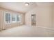 Spacious main bedroom featuring neutral carpet and access to ensuite bath at 13806 E Chenango Dr, Aurora, CO 80015