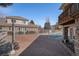 Home's outdoor living space features a brick patio, volleyball net and covered pool at 13806 E Chenango Dr, Aurora, CO 80015