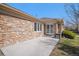 Stone home with a concrete patio and trimmed shrubbery at 13806 E Chenango Dr, Aurora, CO 80015