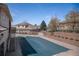 Community pool covered for the winter season with stair access and landscaping at 13806 E Chenango Dr, Aurora, CO 80015