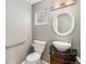 Stylish powder room with unique vessel sink and decorative mirror at 13806 E Chenango Dr, Aurora, CO 80015
