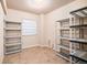 Storage room with vinyl tile floor and metal storage racks at 13806 E Chenango Dr, Aurora, CO 80015