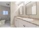 Bright bathroom features double sinks, updated fixtures, and tile shower area at 14701 E Colfax Ave # A5, Aurora, CO 80011