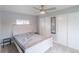 Cozy bedroom featuring a bed, closet with mirror, and bright natural light from window at 14701 E Colfax Ave # A5, Aurora, CO 80011