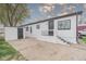 Charming home with black and white trim, featuring a cozy front porch and adjacent storage shed at 14701 E Colfax Ave # A5, Aurora, CO 80011