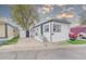 Charming home with black and white trim and front porch, showcasing an adjacent storage shed at 14701 E Colfax Ave # A5, Aurora, CO 80011