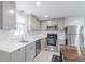 Bright kitchen with stainless steel appliances, modern gray cabinets, and white countertops at 14701 E Colfax Ave # A5, Aurora, CO 80011