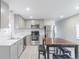 Bright kitchen with stainless steel appliances, a modern countertop, and a wooden dining table at 14701 E Colfax Ave # A5, Aurora, CO 80011