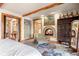 Main bedroom with fireplace, sitting area, and large antique wardrobe at 1138 County Road 65, Evergreen, CO 80439