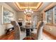 Formal dining room with hardwood floors, chandelier, and large artwork at 1138 County Road 65, Evergreen, CO 80439