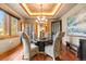 Elegant dining room features a marble table, chandelier, and hardwood floors at 1138 County Road 65, Evergreen, CO 80439