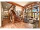 Grand entryway with hardwood floors, wooden staircase, and views into living room at 1138 County Road 65, Evergreen, CO 80439