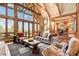 Living room with vaulted ceilings, exposed beams, and views at 1138 County Road 65, Evergreen, CO 80439