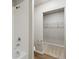 Bathroom with white tile shower and walk-in closet at 48290 Shetland Dr, Bennett, CO 80102